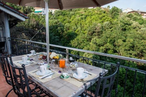 a table on the balcony of a house at Bed & Breakfast Lujocanda in Casarza Ligure