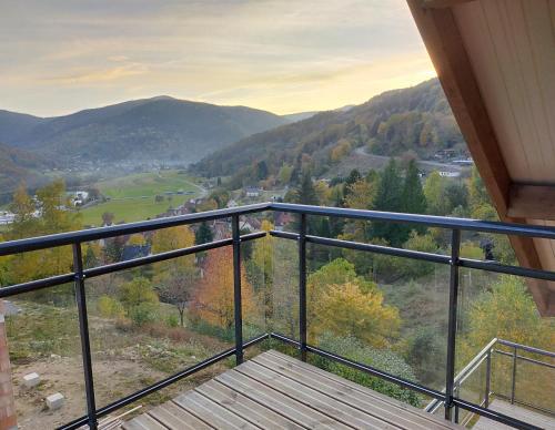 a balcony with a view of the mountains at Au chalet de JO avec accès à l'espace piscine et jacuzzi in Muhlbach-sur-Munster