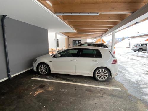 a small white car parked in a garage at Moderne Kaminstube in Ramsau am Dachstein