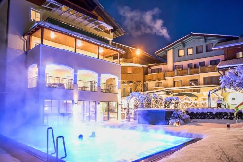 a large swimming pool in front of a building at Hotel Brückenwirt in Sankt Johann im Pongau