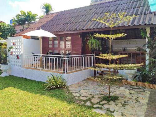 a house with a balcony with a dog on it at Benja369 บ้านเบญจา in Ban Fang Min