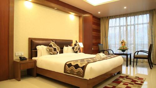 a hotel room with a large bed and a window at HOTEL HEIGA vns in Shillong