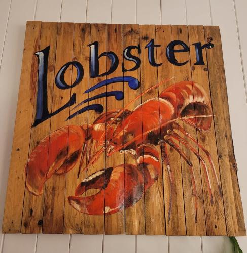 a sign for a lobster on a wall at Enjoy Ventnor 1, Pier Street, Wightlink offer in Ventnor