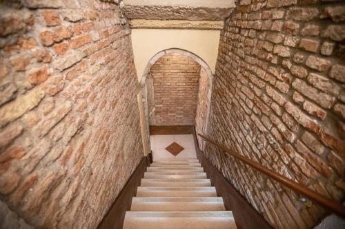 a staircase in an old building with a brick wall at Alla Vigna - Room Only in Venice