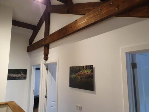 a room with two paintings on the wall at Durbuy Nature in Durbuy
