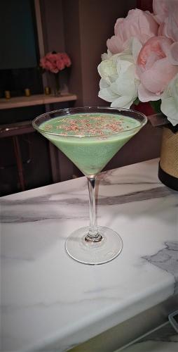 a green drink in a martini glass on a table at Highpoint International Hotel in Gladstone