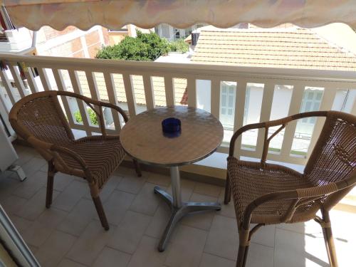a table and two chairs on a balcony at Miami Studios in Loutra Edipsou