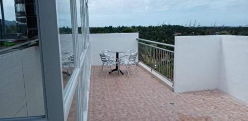 a balcony with a table and chairs on it at Marlene's Hilltop Villa in Cebu City