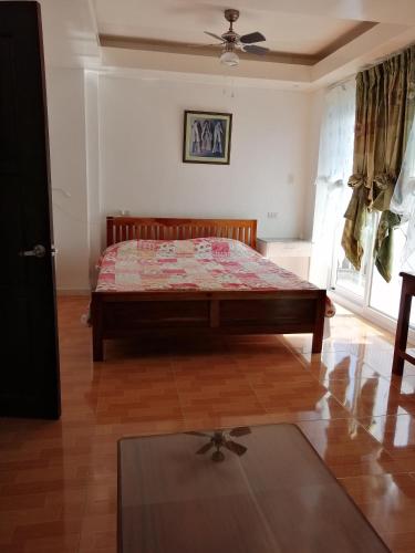 a bedroom with a bed in the corner of a room at Marlene's Hilltop Villa in Cebu City