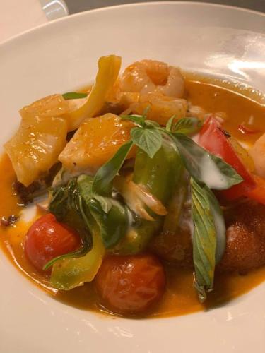 a white plate of food with carrots and other vegetables at Siam cottage guesthouse over 300 years old with Thai restaurant in Moreton in Marsh