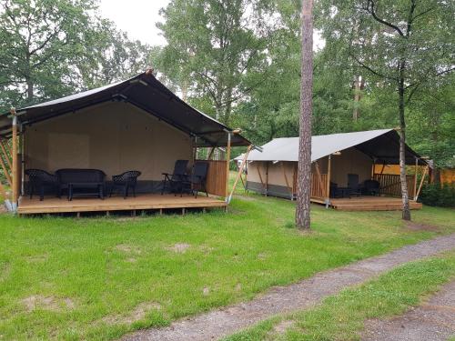 a large tent with tables and chairs in a field at Camping-Aller-Leine-Tal in Engehausen
