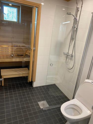 ein Bad mit einer Dusche und einem WC in der Unterkunft New Apartment next to Kuopio Harbour with Sauna in Kuopio