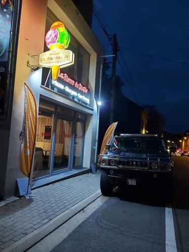 a car parked outside of a restaurant at night at La Pierre du Diable in Stavelot