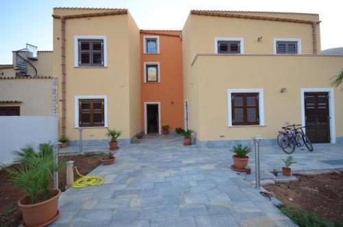 a house with a pathway in front of it at Baia Santa Margherita B&B in Castelluzzo
