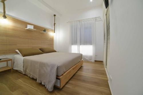 a bedroom with a large bed and a window at La Caletta Bed and Breakfast in Torre Santa Sabina