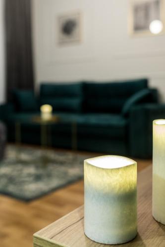 two candles sitting on a table in a living room at Apartman Park in Bijeljina