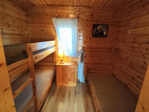 a room with two bunk beds and a window at Morena in Rusinowo
