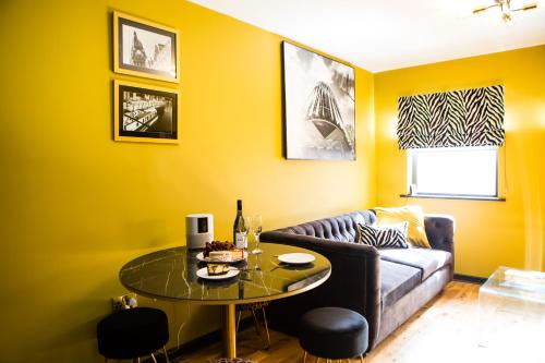 a living room with a couch and a table at Luxury Travel Emporium LS1 - Luxury City Centre Apartments in Leeds