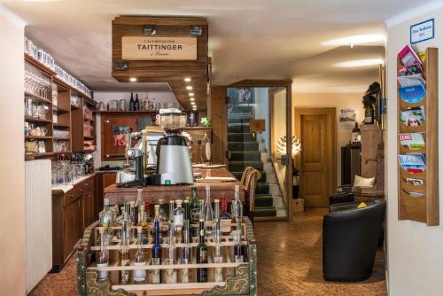 a bar with bottles of wine on a counter at Landgasthof & Restaurant Batzenhäusl in Sankt Gilgen