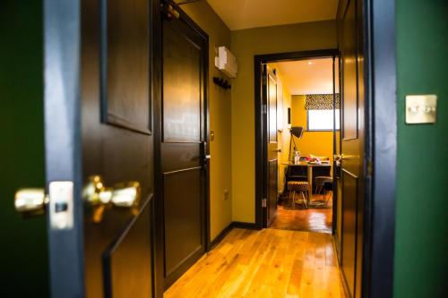 a hallway with a door and a room with a table at Luxury Travel Emporium LS1 - Luxury City Centre Apartments in Leeds