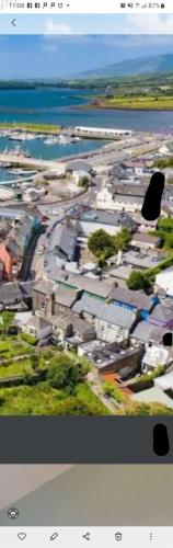 an aerial view of a city with houses and the ocean at Baywatch Inn in Dingle