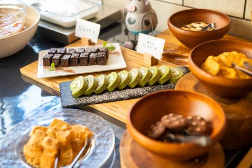 a table topped with different types of food on plates at Hiyori Hotel Osaka Namba Station in Osaka