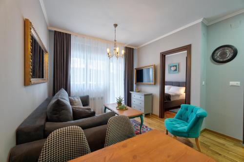 a living room with a couch and a table at Titova Vila Apartman Jelka in Palisad