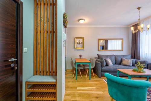 a living room with a couch and a table at Titova Vila Apartman Jelka in Palisad