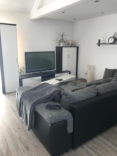 a living room with a couch and a flat screen tv at Jeannette in Balingen