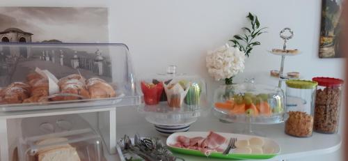 a refrigerator filled with food and a plate of food at Le Perle d'Italia in Ravello