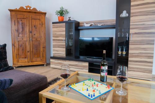 a living room with a table with a cake and wine glasses at Stoabergblick in Lofer