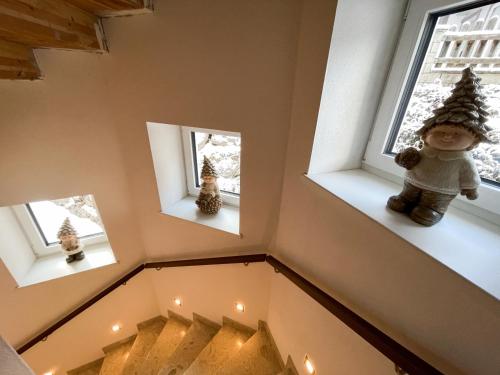a set of three windows with christmas trees in them at Stoabergblick in Lofer