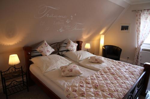 a bedroom with a bed with two pillows on it at Haus Wattenmeer in Tönning