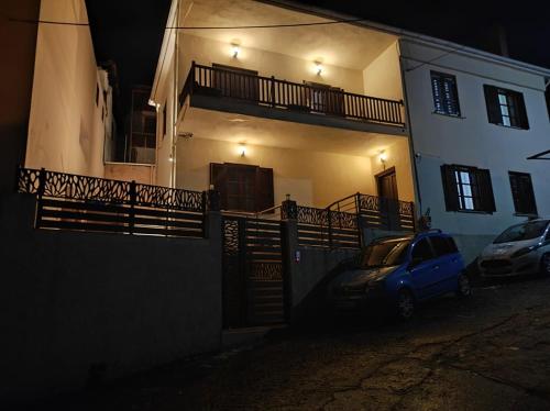 a car parked in front of a house at night at Grand View Apartment in Panagia