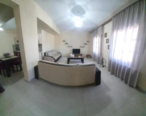 a large living room with a couch and a table at Grand View Apartment in Panagia