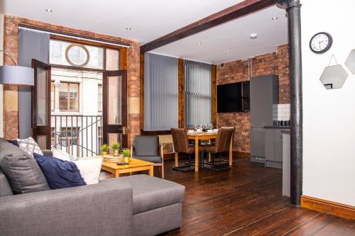 a living room with a couch and a table at 27 Stanley Street Aparthotel by UStay in Liverpool