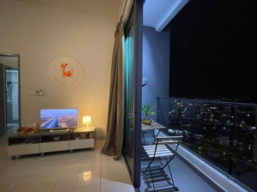 a room with a balcony with a view of a city at LakePark Residence KL North in Batu Caves