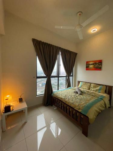 a bedroom with a bed and a large window at LakePark Residence KL North in Batu Caves
