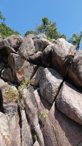 a pile of large rocks with trees in the background at Tao Thong Villa 2 in Ko Tao