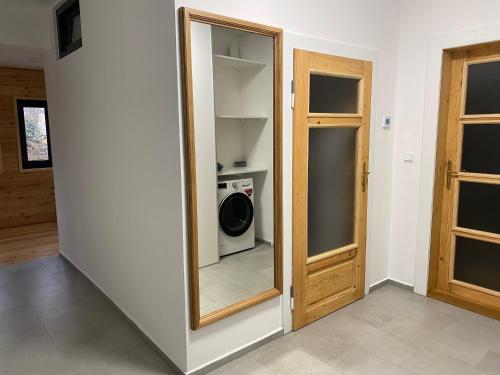 a room with a mirror and a washing machine at Vila Kosmonautka - Velké Losiny in Velké Losiny