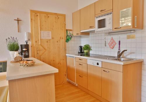 a kitchen with a sink and a counter top at ROSENHOF- Premium & Landhaus Apartments & Wellness & Erlebnisbauernhof in Nauders