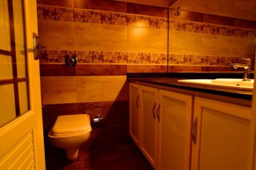 a bathroom with a toilet and a sink at Heaven Valley Resorts Vagamon in Vagamon