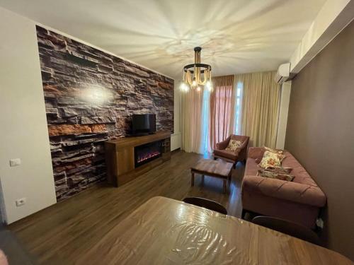 a living room with a couch and a fireplace at 7th HEAVEN Apartment in Central Tbilisi in Tbilisi City