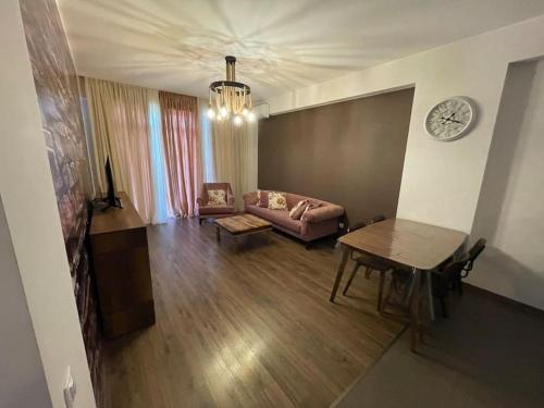 a living room with a couch and a table at 7th HEAVEN Apartment in Central Tbilisi in Tbilisi City