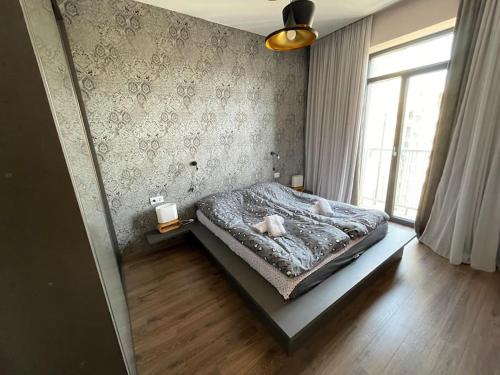 a bedroom with a bed and a window at 7th HEAVEN Apartment in Central Tbilisi in Tbilisi City