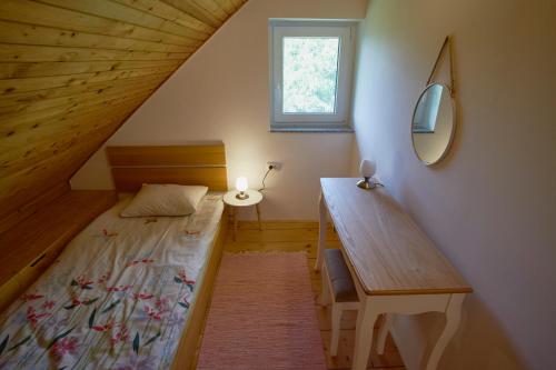 A bed or beds in a room at Holiday House Podhamer Boris_private Wellness