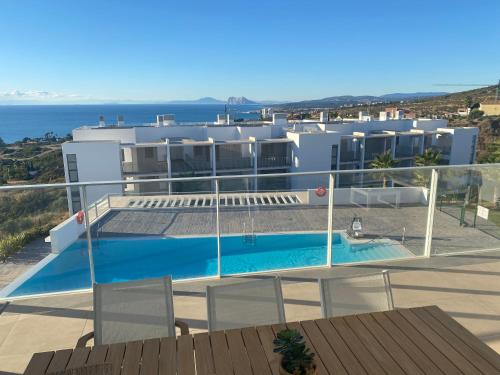 a large white building with a swimming pool on a balcony at Sunrise Heights Manilva Costa Del Sol, Andalousie in Manilva