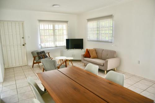 a living room with a table and a couch at FonteinZen - Home with big garden at Fontein in Willemstad