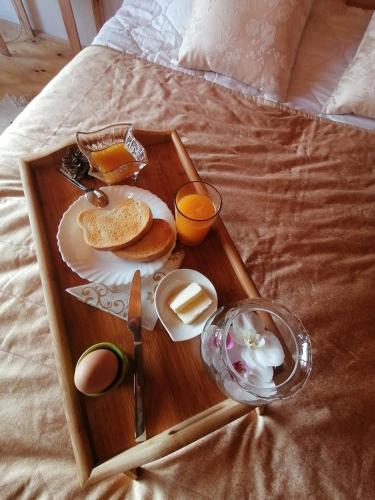 a tray of breakfast food on a bed at Vila Mila Fruška Gora in Velika Remeta