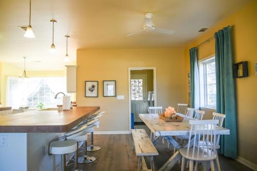 a kitchen with yellow walls and a table and chairs at Sierra Ranch - A Yosemite Retreat in Mariposa